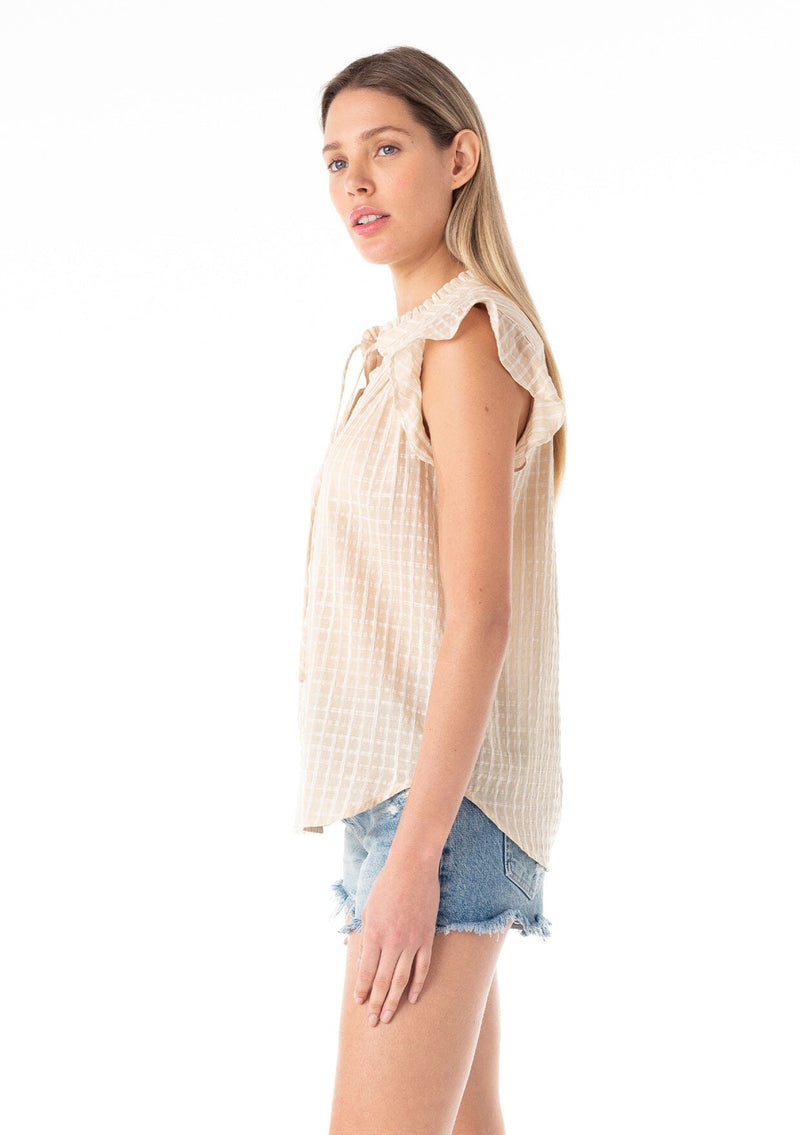 [Color: Natural] A side facing image of a blonde model wearing a best selling button front blouse in a natural cotton seersucker check print. With short flutter sleeves, a ruffled neckline, and neck ties.