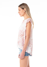 [Color: Ivory/Light Rust] A side facing image of a blonde model wearing a light spring top in a white and pink floral print. With short ruffled sleeves, a split v neckline, and a relaxed fit. 