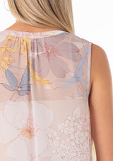 [Color: Natural/Blue] A close up back facing image of a blonde model wearing a pretty spring chiffon tank top designed in a pink and blue floral print. With a self covered button front, a button loop trimmed split v neckline, and a relaxed fit. 