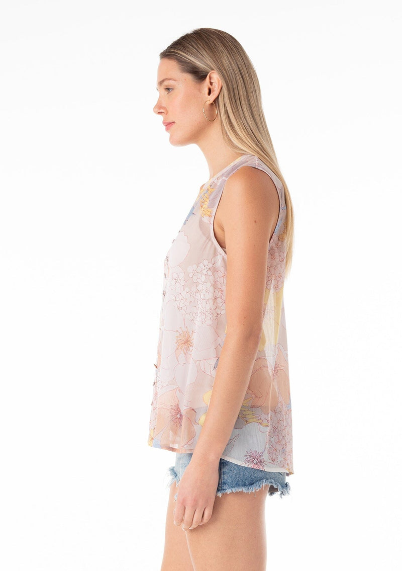 [Color: Natural/Blue] A side facing image of a blonde model wearing a pretty spring chiffon tank top designed in a pink and blue floral print. With a self covered button front, a button loop trimmed split v neckline, and a relaxed fit. 