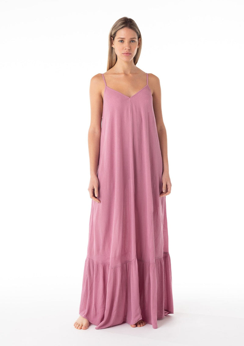 [Color: Smokey Orchid] A full body front facing image of a blonde model wearing a simple flowy sleeveless maxi tank dress in a light purple crinkle rayon. With a v neckline in front and back, adjustable spaghetti straps, and a tiered skirt. 