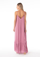 [Color: Smokey Orchid] A back facing image of a blonde model wearing a simple flowy sleeveless maxi tank dress in a light purple crinkle rayon. With a v neckline in front and back, adjustable spaghetti straps, and a tiered skirt. 
