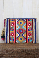 [Color: Khaki/Pink Multi] A multi color embroidered cotton clutch with a tassel zipper pull. 