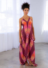 [Color: Wine/Pink] A model wearing a sheer cotton tie dye scarf dress. With a handkerchief hemline, front keyhole detail, and sexy adjustable strappy back.