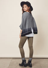 [Color: Charcoal/Midnight] A model wearing a relaxed grey dyed sweatshirt with a scoop neckline, long batwing sleeves, and raw edge finish details. 