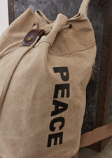 [Color: Beige] A cotton blend beige sack backpack with a drawstring closure. 