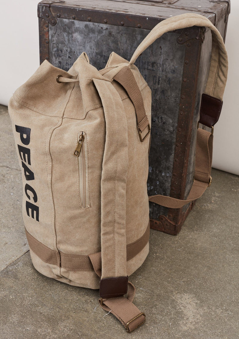[Color: Beige] A cotton blend beige sack backpack with a drawstring closure. 