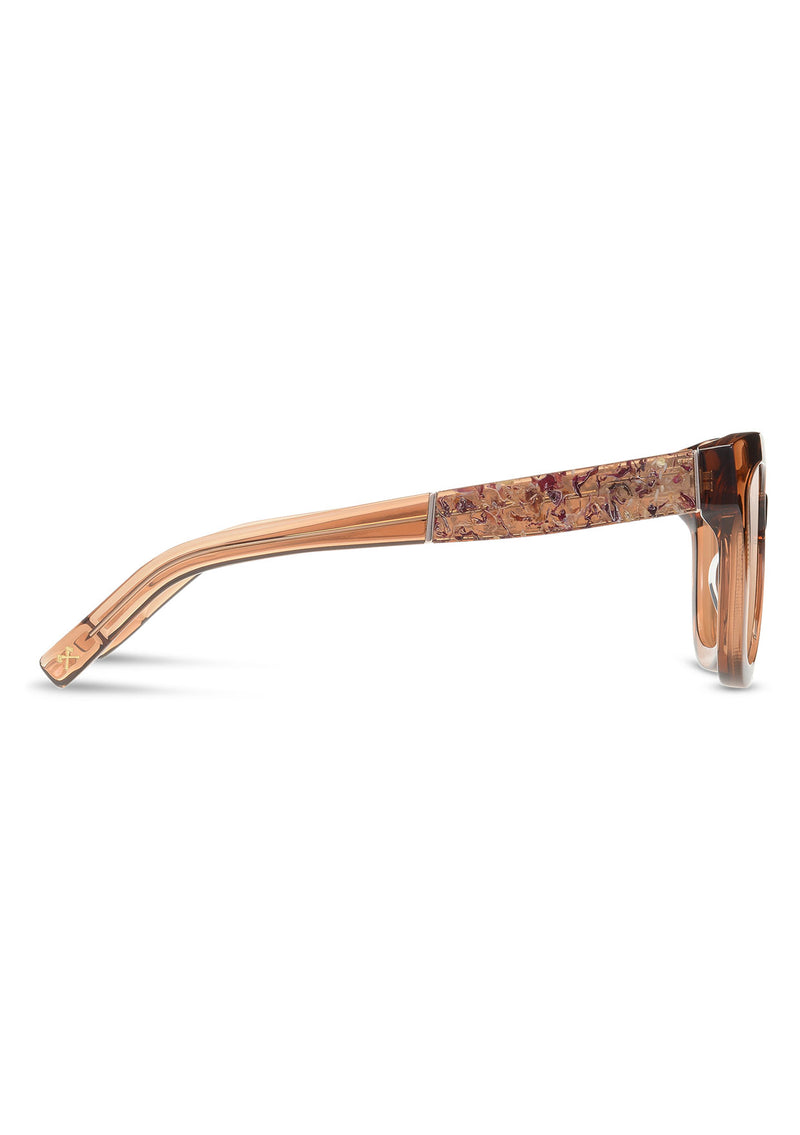 [Color: Copper] Sunglasses with a warm brown lens and a rose flower inlay.