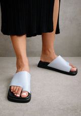 [Color: Baby Blue] Alohas baby blue flop leather flat slip on sandal with a toe ring detail. 